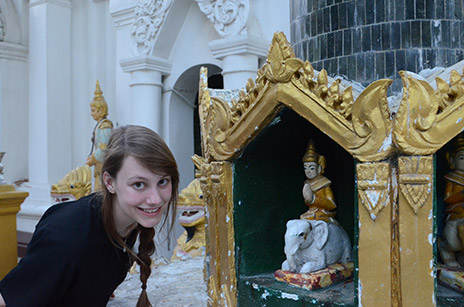 Jessica Anania posing in front of a Buddha statue