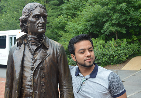 Anurag Chandran with a statue of Thomas Jefferson.