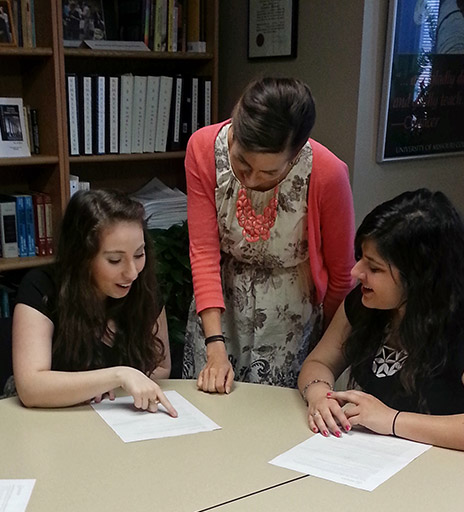 Kristina Wright works with students around a table